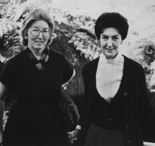 Two women stand together in black and white photo