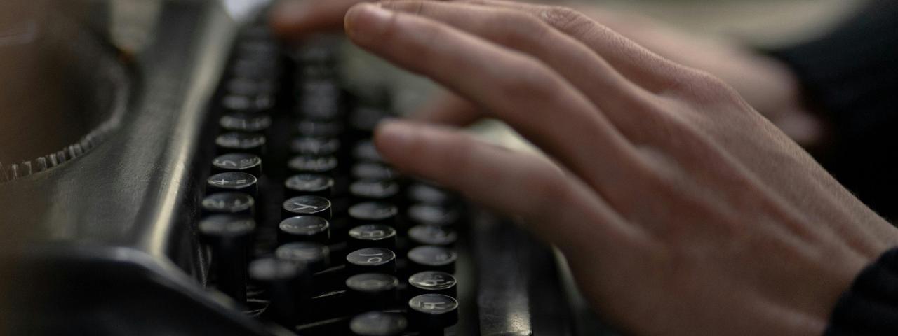 Close up of hands using a typerwriter
