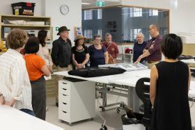 Group of people looking at material in the collection care labs