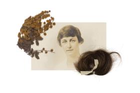 A sepia photograph of a woman framed by dried wattle sprig and a lock of hair.