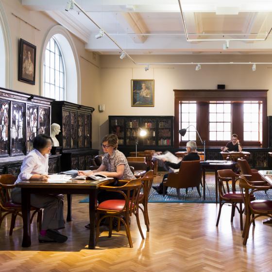 Men and women reading in large plush room