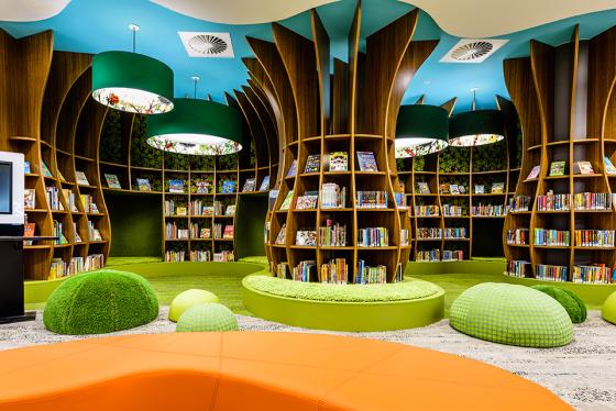 Children's library with bookshelves and seating in the design of a forest