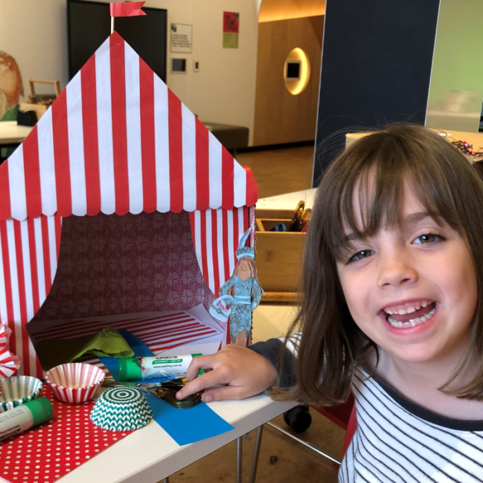 little girl smiling with circus tent craft in JBF
