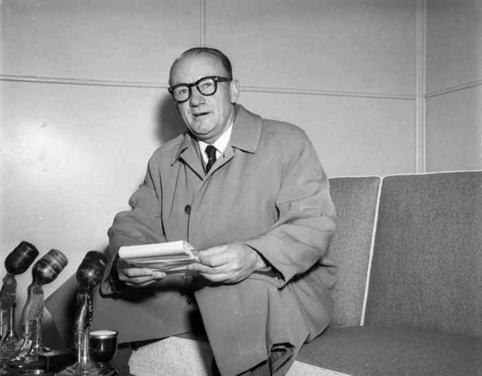 Sir Donald Bradman gives a press conference on his return from a cricket conference, Mascot. Photo by Jack Hickson